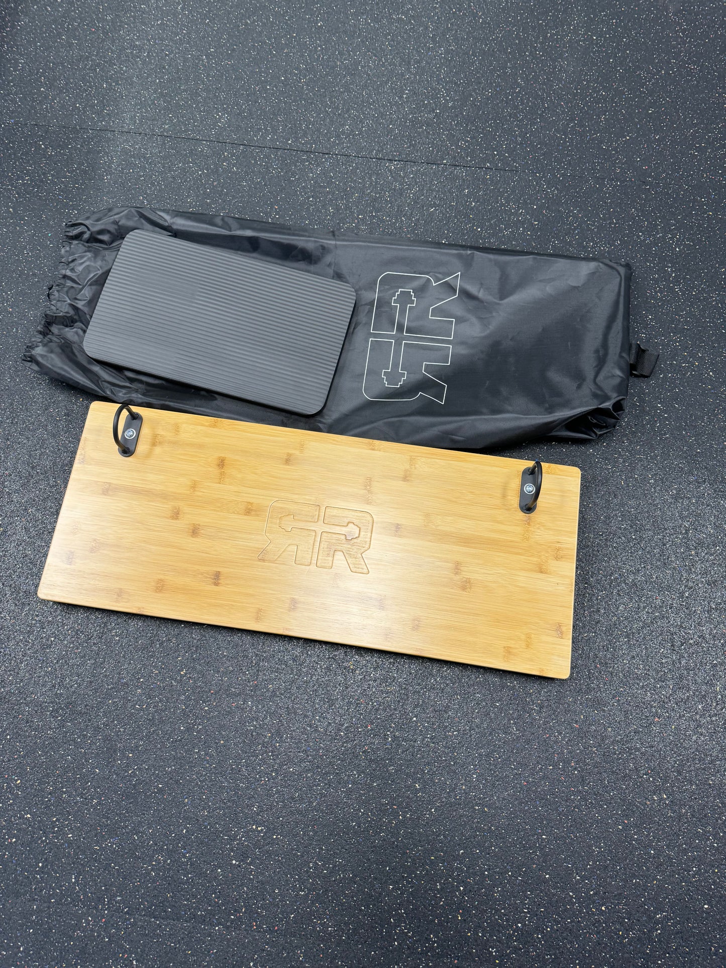 Ripped Rosenblatt Core Saber set with bamboo board, pad, and carry bag on black gym floor.